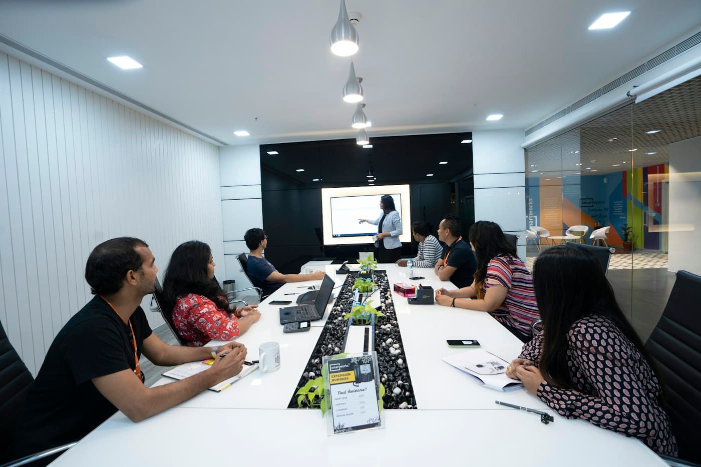 A facilitator leading professionals through a collaborative capacity-building workshop