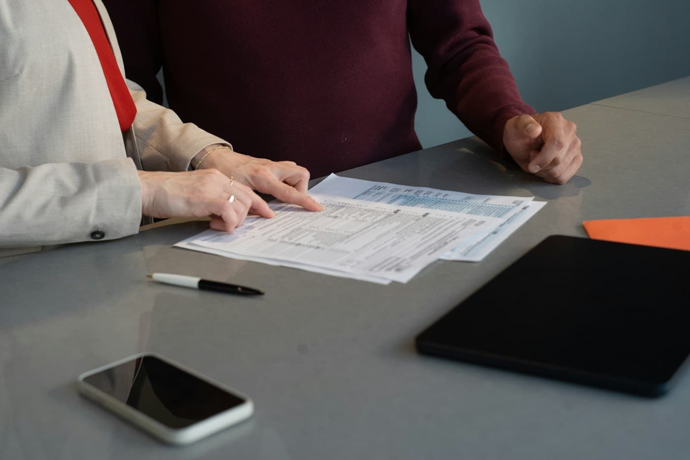 Professionals reviewing detailed financial records together