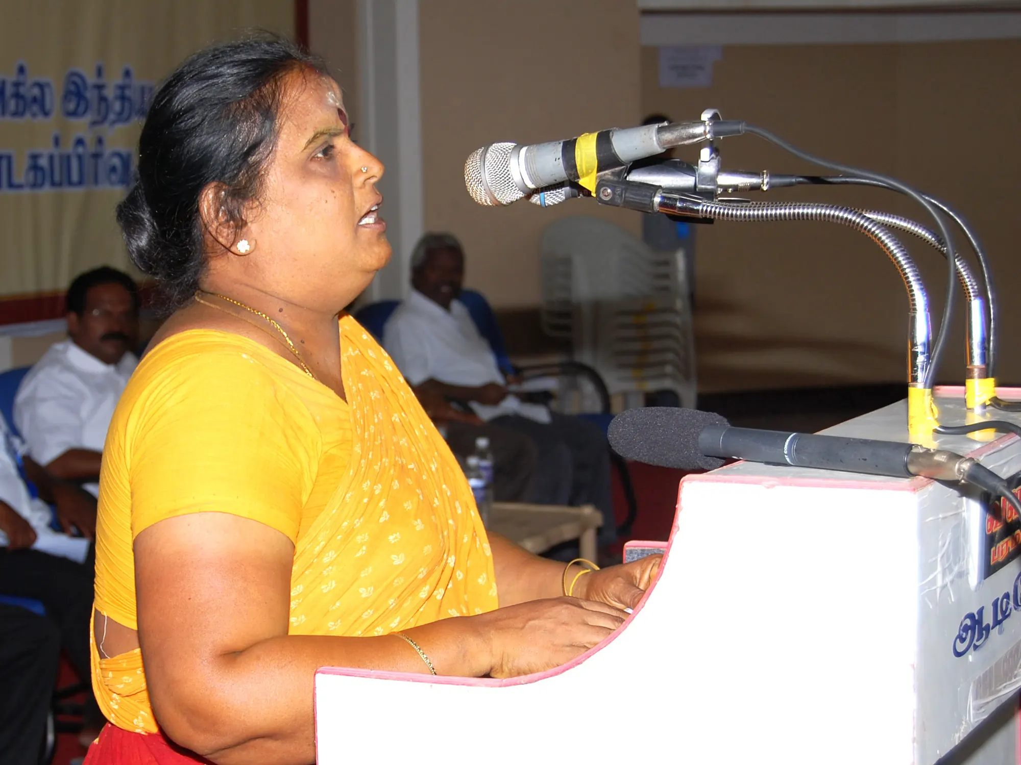 A self-help group leader addressing a community session